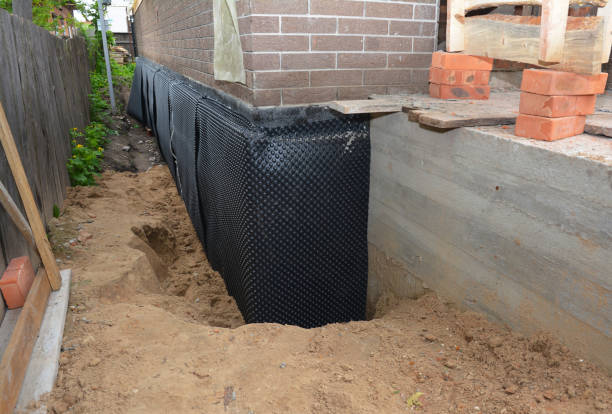 SJ Waterproofing Pros technician performing targeted Wet Basement Repair assessment in Endeavor, WI